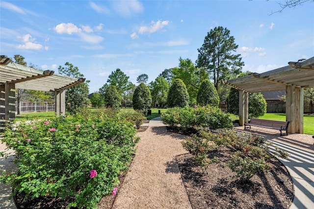 view of community featuring a pergola and fence