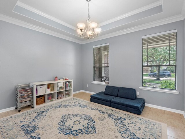 sitting room with a chandelier, healthy amount of natural light, a raised ceiling, and crown molding