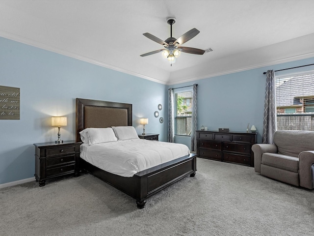 carpeted bedroom featuring crown molding, a ceiling fan, and baseboards