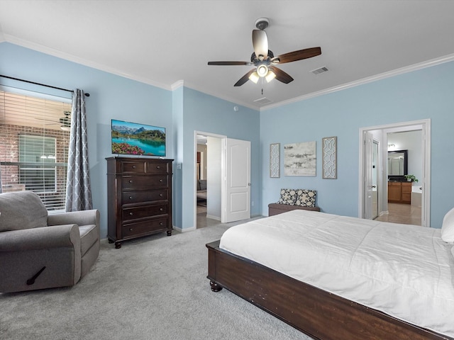 carpeted bedroom featuring crown molding, ensuite bath, baseboards, and a ceiling fan