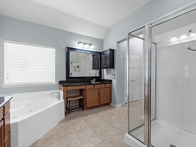 full bathroom featuring vanity, a shower stall, tile patterned flooring, a garden tub, and lofted ceiling