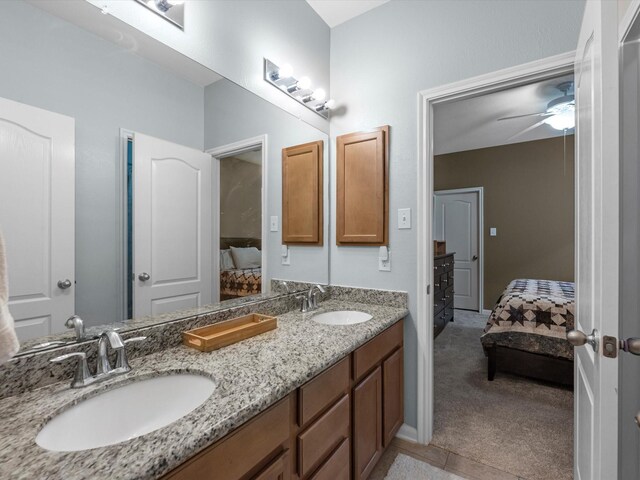 bathroom featuring ensuite bath, double vanity, tile patterned floors, and ceiling fan