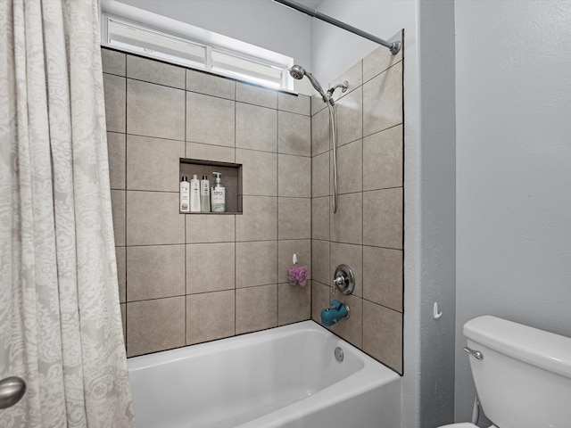 full bathroom featuring shower / tub combo and toilet