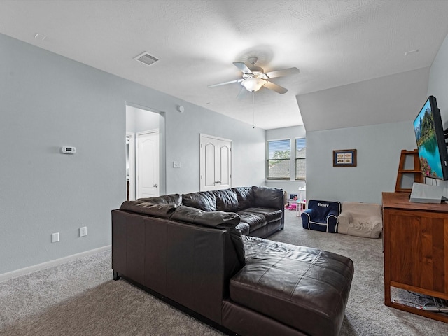 carpeted living area featuring a ceiling fan and baseboards