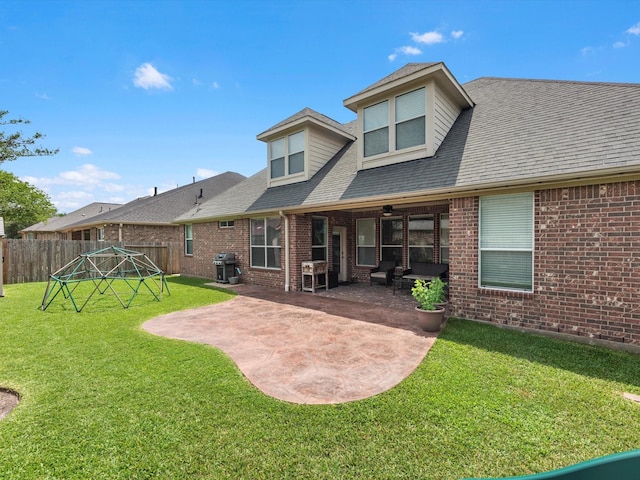 back of property featuring a patio, brick siding, and a shingled roof