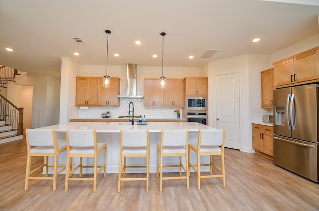 11610 Bryson Creek Ct, Cypress, TX 77433 - kitchen with appliances with stainless steel finishes, wall chimney range hood, light wood-style flooring, backsplash, and light countertops