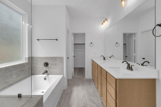 8235 Red Shiner Way, Fulshear, TX 77441 - bathroom with a bath, double vanity, a spacious closet, and marble look tile flooring