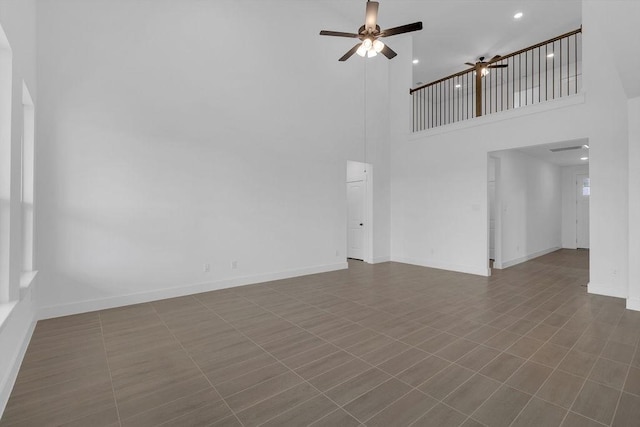 8235 Red Shiner Way, Fulshear, TX 77441 - unfurnished living room featuring ceiling fan, a towering ceiling, and recessed lighting