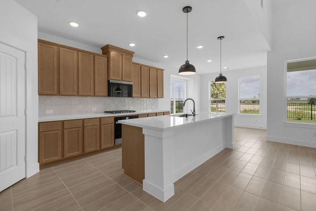 8235 Red Shiner Way, Fulshear, TX 77441 - kitchen featuring oven, black microwave, healthy amount of natural light, brown cabinetry, and recessed lighting