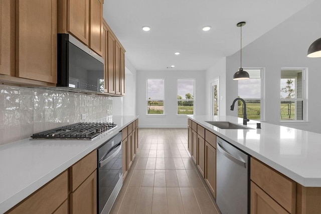 8235 Red Shiner Way, Fulshear, TX 77441 - kitchen with stainless steel appliances, backsplash, light countertops, recessed lighting, and brown cabinetry