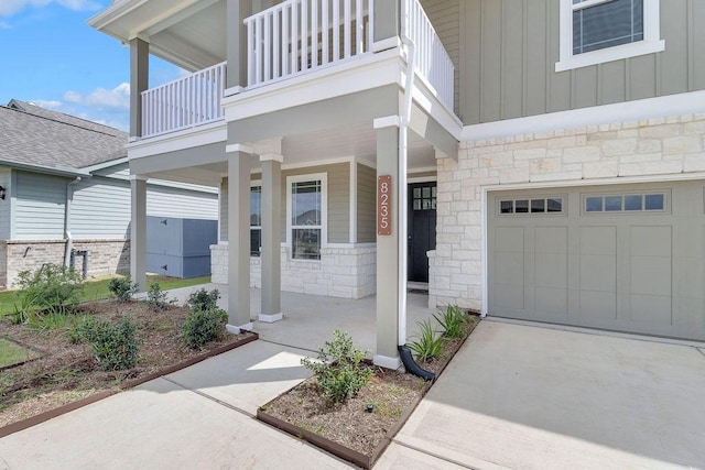 8235 Red Shiner Way, Fulshear, TX 77441 - property entrance featuring stone siding, a porch, board and batten siding, and an attached garage