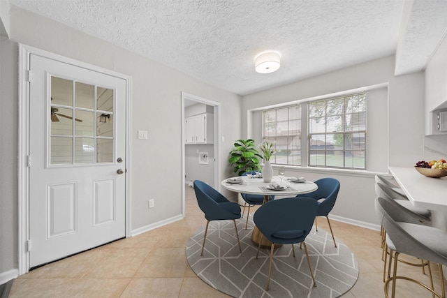 3915 Glenheather Dr, Houston, TX 77068 - dining space with baseboards, light tile patterned flooring, and a textured ceiling