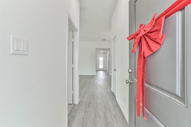 hall with wood finished floors and baseboards
