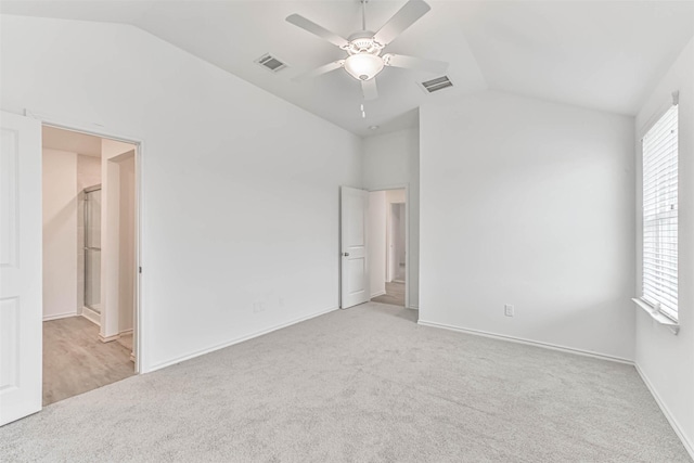 unfurnished bedroom featuring vaulted ceiling, carpet flooring, baseboards, and ceiling fan