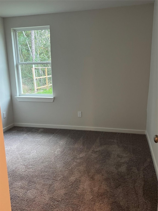 carpeted empty room with baseboards