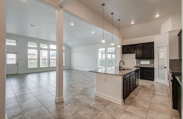 kitchen featuring open floor plan, light stone counters, backsplash, light tile patterned flooring, and recessed lighting
