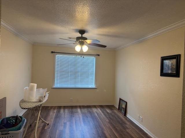 unfurnished dining area featuring a ceiling fan, wood finished floors, a textured ceiling, ornamental molding, and baseboards