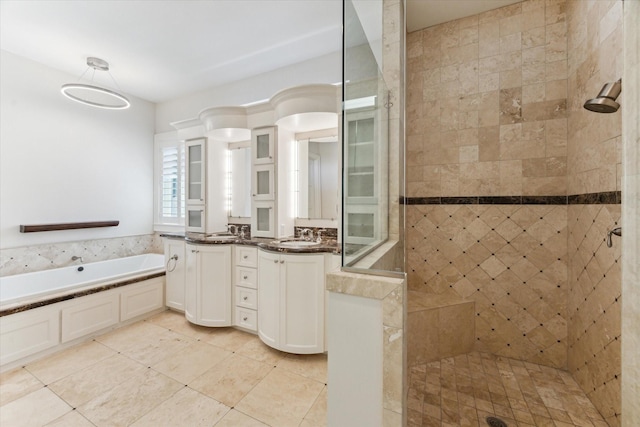 6216 Queenswood Ln, Houston, TX 77008 - bathroom featuring a tile shower, a garden tub, tile patterned floors, and double vanity
