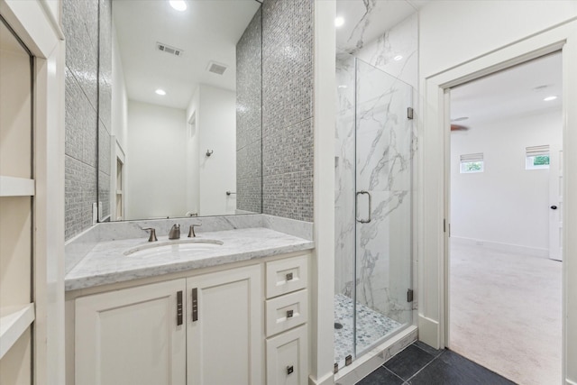 6216 Queenswood Ln, Houston, TX 77008 - bathroom with a marble finish shower, tile patterned floors, vanity, and recessed lighting