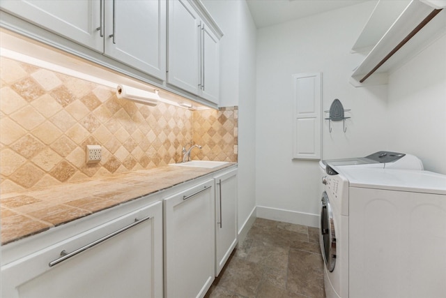 6216 Queenswood Ln, Houston, TX 77008 - laundry area featuring cabinet space, separate washer and dryer, dark stone finish floors, and baseboards