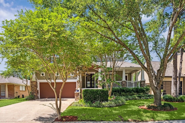 6216 Queenswood Ln, Houston, TX 77008 - view of front of property featuring stone siding, concrete driveway, a front yard, covered porch, and a garage