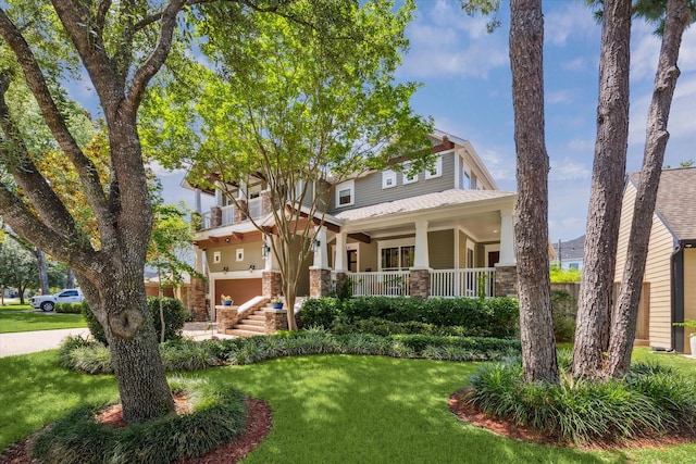6216 Queenswood Ln, Houston, TX 77008 - view of front of home with a front yard, a porch, an attached garage, and stone siding