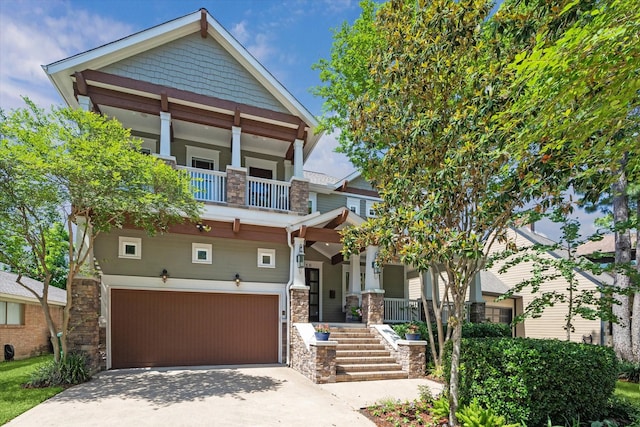 6216 Queenswood Ln, Houston, TX 77008 - craftsman house with a garage, covered porch, concrete driveway, a balcony, and stone siding