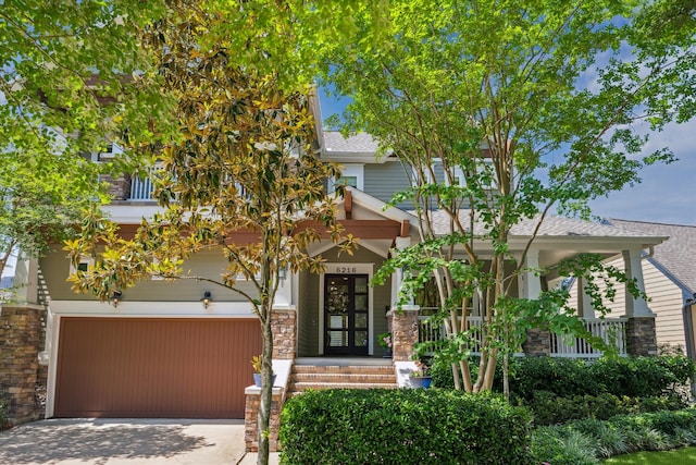 6216 Queenswood Ln, Houston, TX 77008 - obstructed view of property featuring concrete driveway, stone siding, a garage, and a shingled roof