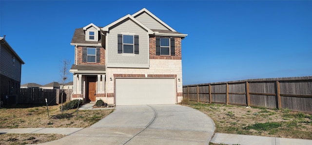 view of front facade featuring driveway, brick siding, fence, and an attached garage