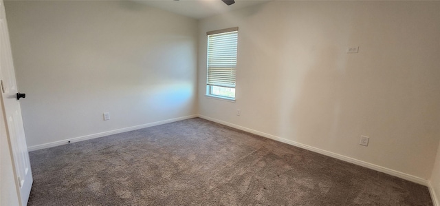 carpeted empty room with a ceiling fan and baseboards