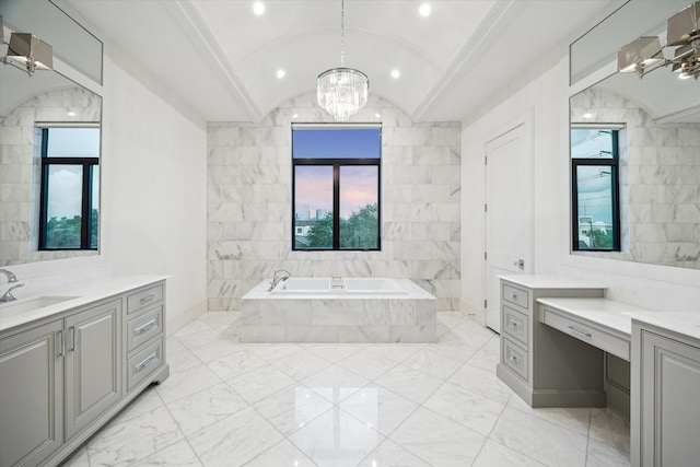 bathroom with a chandelier, a bath, marble finish floors, and plenty of natural light