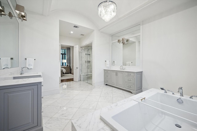 full bath with marble finish floors, a garden tub, a shower stall, two vanities, and ensuite bathroom