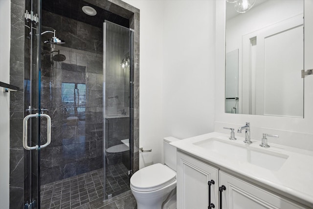 full bath with toilet, a shower stall, and vanity