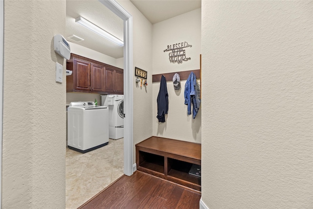 18814 Luby Creek Dr, Cypress, TX 77433 - mudroom with washer and clothes dryer, a textured wall, wood finished floors, and baseboards
