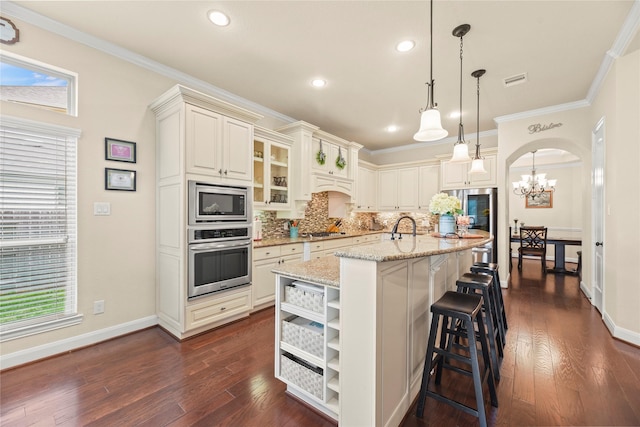 18814 Luby Creek Dr, Cypress, TX 77433 - kitchen with stainless steel appliances, open shelves, tasteful backsplash, a breakfast bar area, and light stone counters