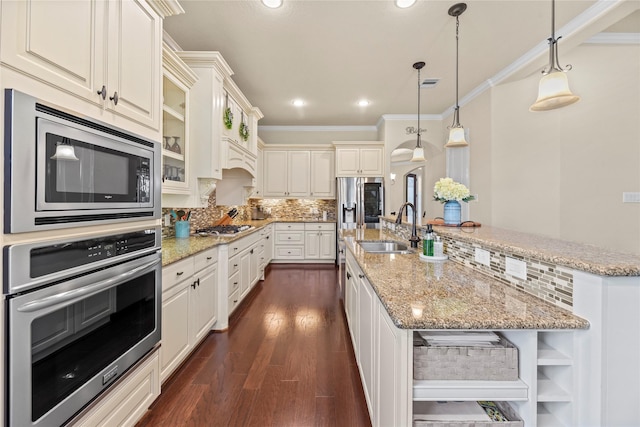 18814 Luby Creek Dr, Cypress, TX 77433 - kitchen featuring stainless steel appliances, a sink, crown molding, dark wood finished floors, and a kitchen island with sink