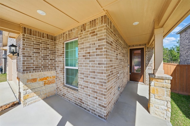820 Dawn Redwood Ct, Conroe, TX 77304 - view of exterior entry with brick siding and fence