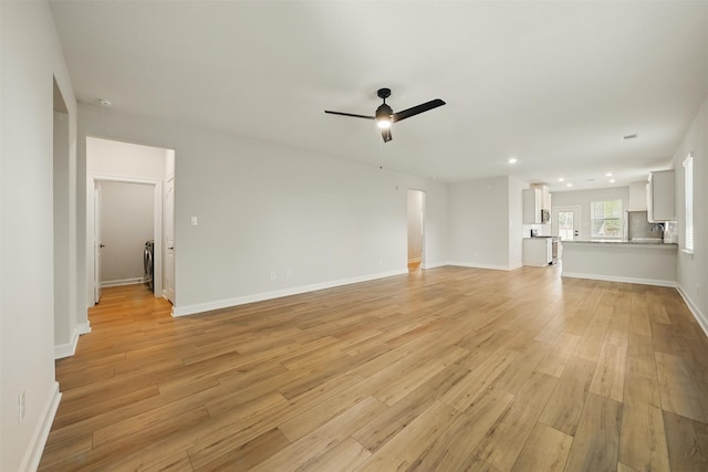 820 Dawn Redwood Ct, Conroe, TX 77304 - unfurnished living room featuring a ceiling fan, light wood-type flooring, recessed lighting, baseboards, and washer / dryer