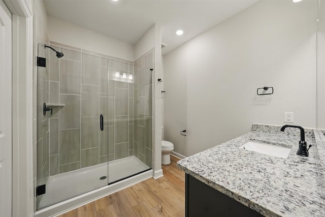 820 Dawn Redwood Ct, Conroe, TX 77304 - full bathroom featuring toilet, a stall shower, vanity, wood finished floors, and recessed lighting