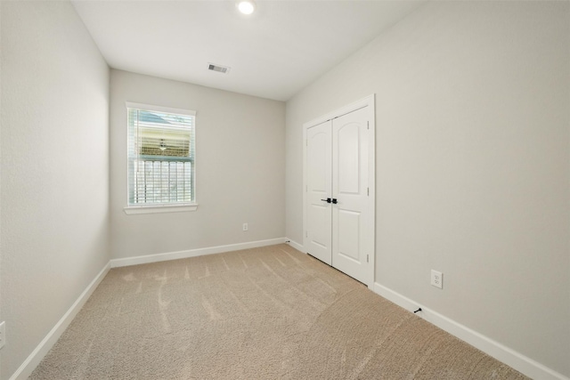 820 Dawn Redwood Ct, Conroe, TX 77304 - unfurnished bedroom featuring baseboards, light colored carpet, and a closet