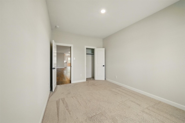 820 Dawn Redwood Ct, Conroe, TX 77304 - unfurnished bedroom featuring light colored carpet, baseboards, a closet, and recessed lighting