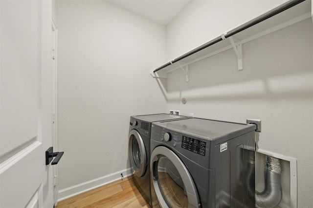 820 Dawn Redwood Ct, Conroe, TX 77304 - clothes washing area featuring separate washer and dryer, light wood-style flooring, and baseboards