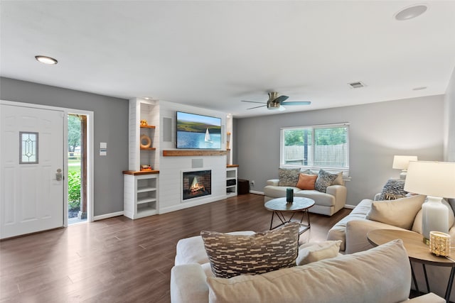 living area with wood finished floors, baseboards, a fireplace, ceiling fan, and recessed lighting