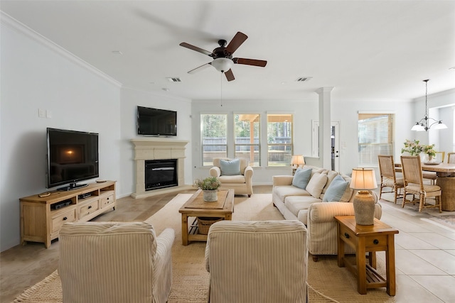 2642 Tacoma Springs Dr, Conroe, TX 77304 - living room featuring healthy amount of natural light, ceiling fan, a glass covered fireplace, ornamental molding, and light tile patterned flooring