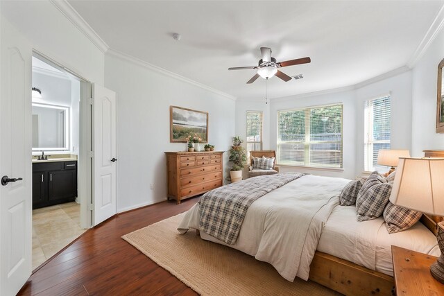 2642 Tacoma Springs Dr, Conroe, TX 77304 - bedroom with crown molding, light wood-style flooring, ensuite bathroom, a ceiling fan, and baseboards