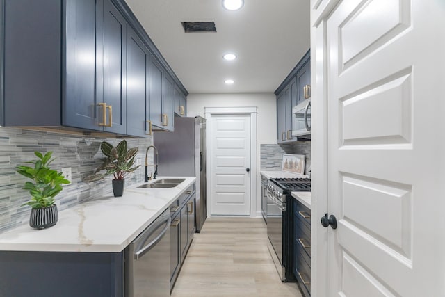 3618 Tamfield Dr, Houston, TX 77066 - kitchen featuring stainless steel appliances, a sink, recessed lighting, light wood-style floors, and tasteful backsplash