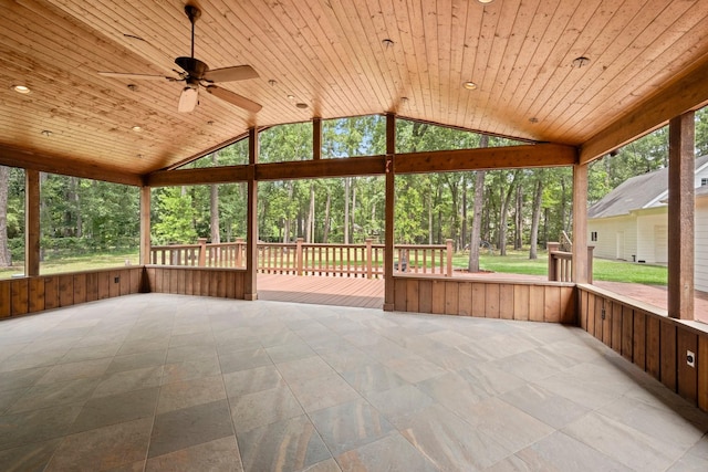 10 Hollow Glen Ln, Tomball, TX 77375 - unfurnished sunroom featuring ceiling fan, vaulted ceiling, and view of wooded area