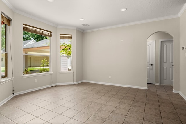 10 Hollow Glen Ln, Tomball, TX 77375 - empty room with arched walkways, light tile patterned floors, ornamental molding, recessed lighting, and baseboards