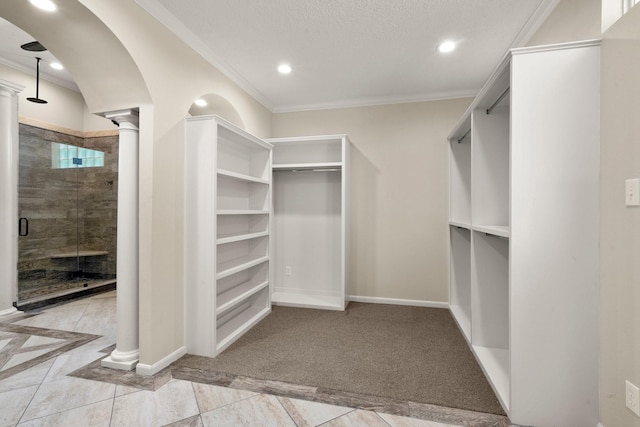 10 Hollow Glen Ln, Tomball, TX 77375 - walk in closet with decorative columns, inlaid floor details, and arched walkways