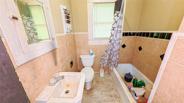 411 Kernohan St, Crosby, TX 77532 - bathroom with tile walls, toilet, a sink, and wainscoting
